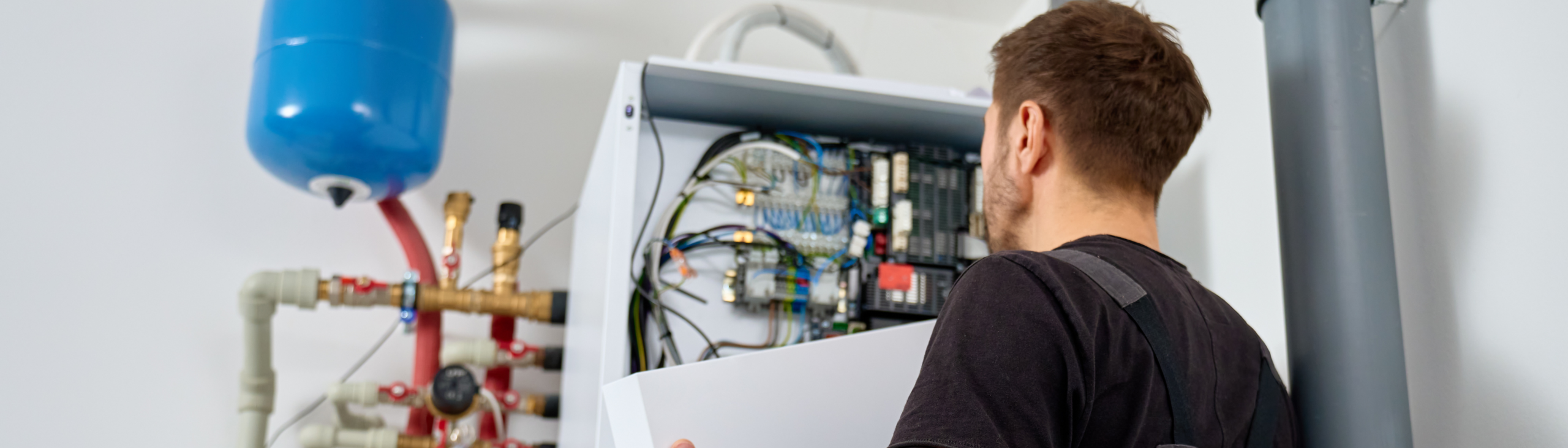 Man aan het werk bij een warmtepomp in huis